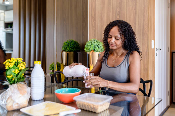 istock Breakfast table with cereal, plastic milk jars and bag of bread 1311012425