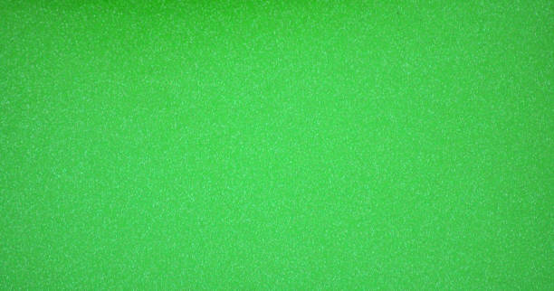 istock Monochrome bright green surface with a scattering of small silvery shiny blotches. 1311015993