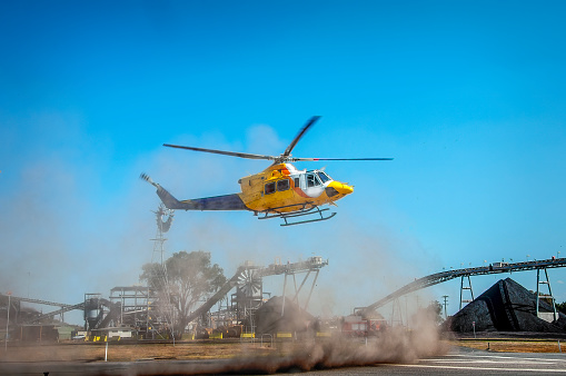 Helicopter landing at an open cut coal mine