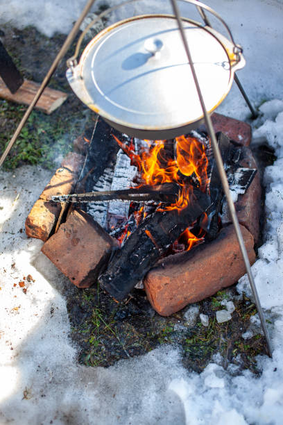istock Over the fire hangs a pot in which to cook food. 1311016809