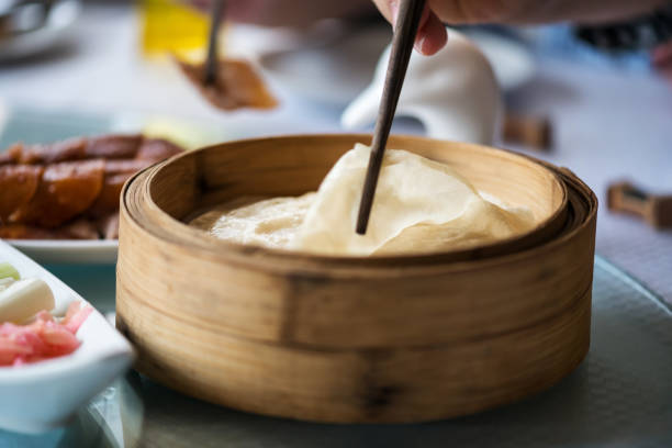 istock grab pancake by chopstick near Peking duck 1311023980