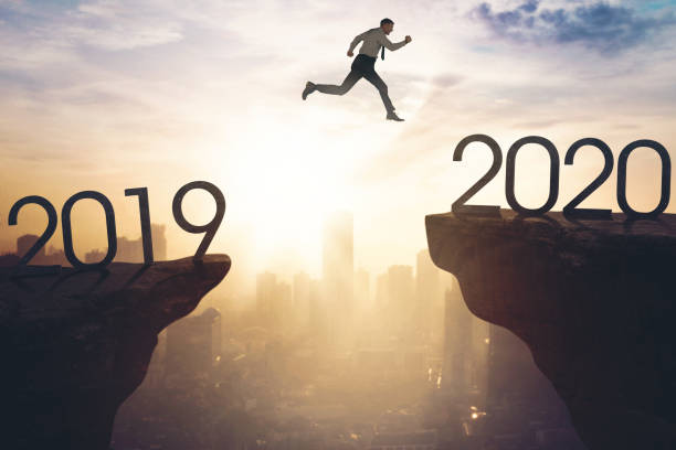 istock Young businessman jumps to number 2020 1311024901
