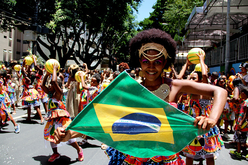 Porto Alegre, Rio Grande do Sul, Brazil - Mar 01st, 2014: Brazilian carnival musician playing tambourine and a dancer on parade