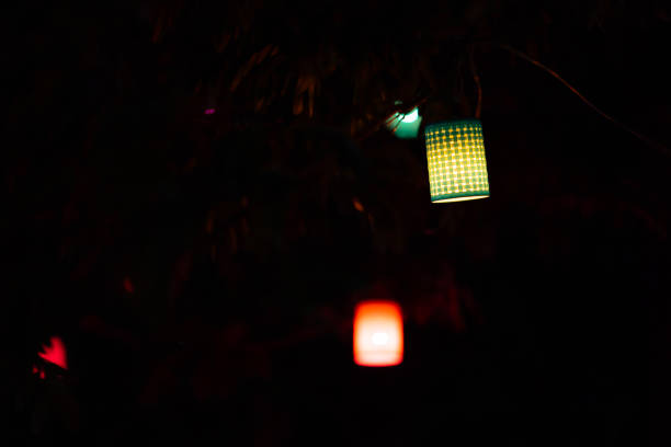 istock lamp to colorful light on dark night background 1311027502