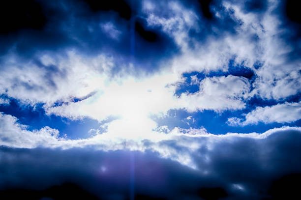 Beautiful sunrise clouds on a summer morning with pinks and blues. Cloudy cloud background and texture. Cluster of clouds with gloomy colors. Sunrise sky landscape travel serene tranquil view with multiple beautiful natural colors.