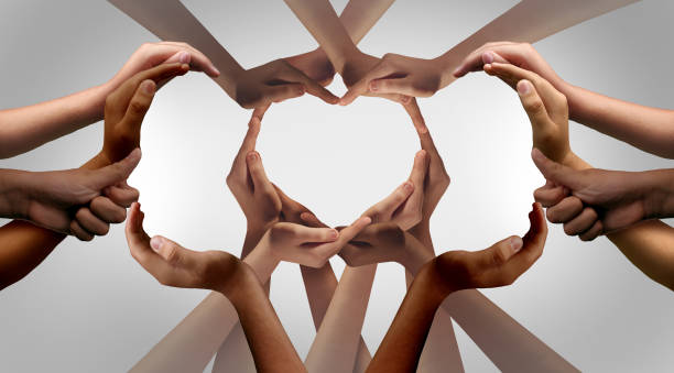 Unity And Togetherness Unity and Togetherness or diversity partnership as heart hands in a group of diverse people connected together shaped as a support symbol expressing the feeling of teamwork. diversity hands forming heart stock pictures, royalty-free photos & images