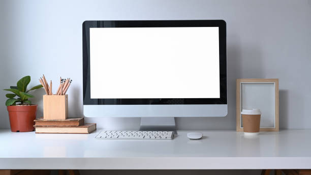 istock Home office desk with computer, house plant, books and coffee cup. 1311033004