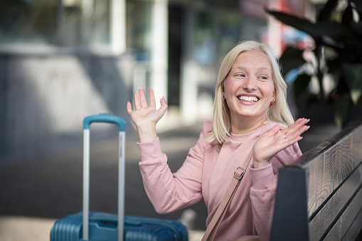 Happy Woman sitting on bus station.