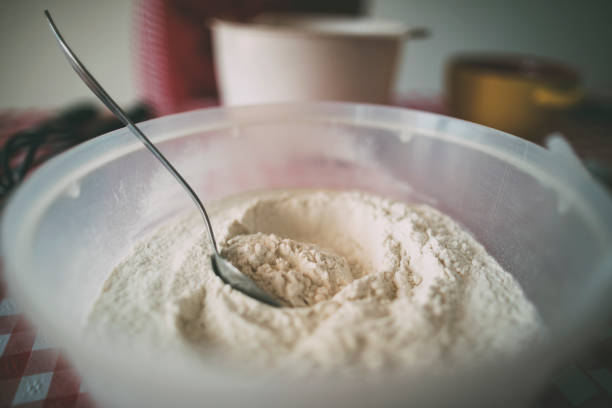 Bowl of flour with spoon in.