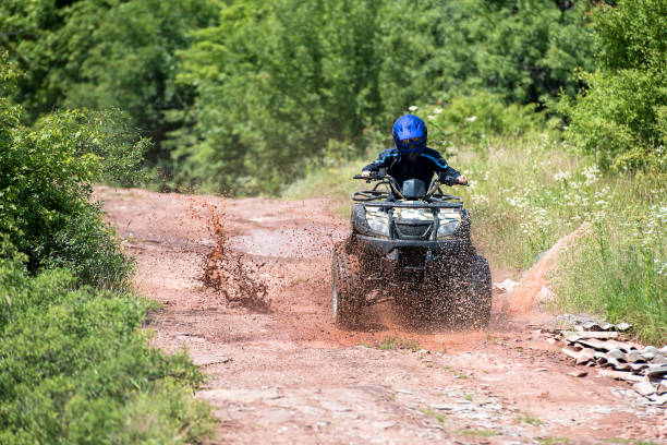 istock A trip on the ATV on the red road. 1311036383