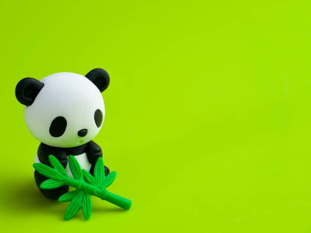 istock Cute panda figure eating bamboo background 1311040919
