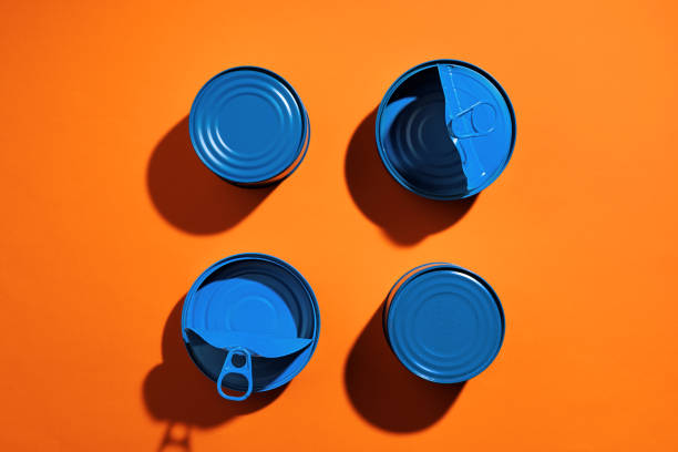 istock Aesthetic concept with blue painted tin can on orange background 1311041188