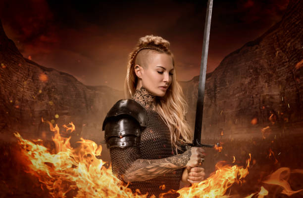 istock Weapon wielding viking inspired warrior female in a fantasy fire setting 1311042241