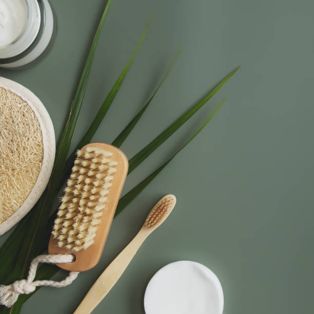 istock Bath accessories flat lay on green background. Healthcare concept, palm leaf 1311042496