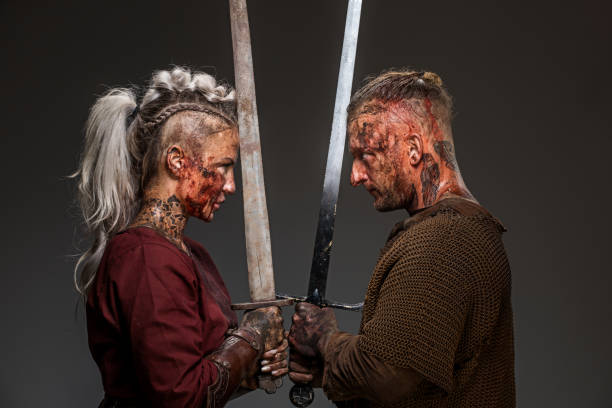 istock Blood and mud covered viking warrior couple in studio shot 1311042544