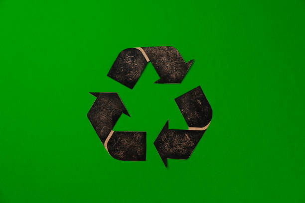 istock Paper recycling concept on green background top view 1311043400