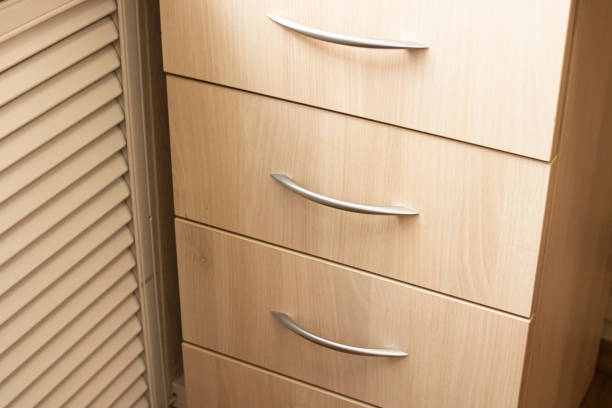 istock Handles on a drawer on wooden table 1311044847