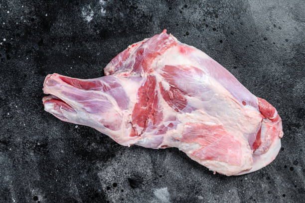 istock Raw lamb shoulder meat. Black background. Top view 1311045989