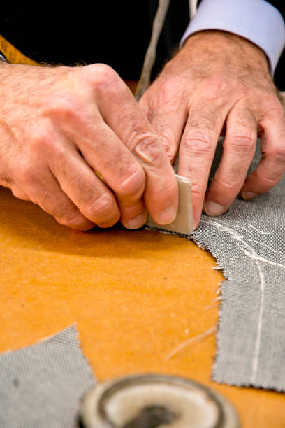 istock hands of an Italian tailor measuring a tailored suit 1311047656