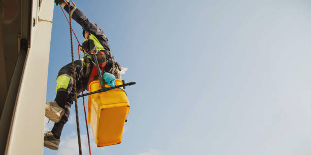 istock Industrial mountaineering worker hangs over residential facade building while washing exterior facade glazing 1311047908