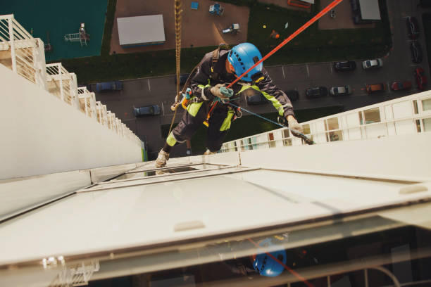 istock Industrial mountaineering worker hangs over residential facade building while washing exterior facade glazing 1311047932