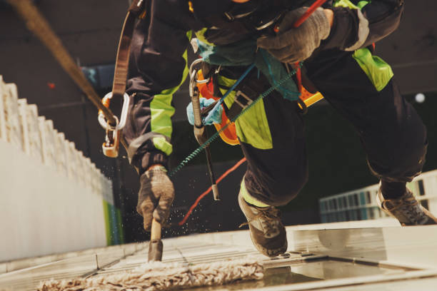 istock Industrial mountaineering worker hangs over residential facade building while washing exterior facade glazing 1311047943