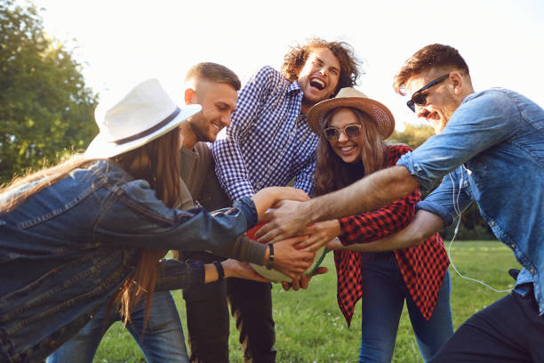 istock Cheerful friends playing with a ball in the park. 1311048979