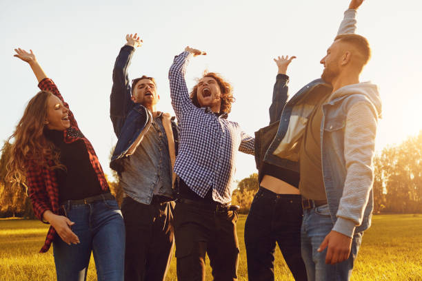 istock Cheerful friends raised their hands up in the  park . 1311048981