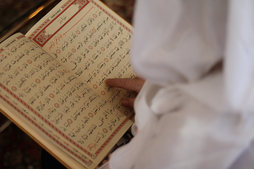 Old Muslim woman reciting the Holy Quran