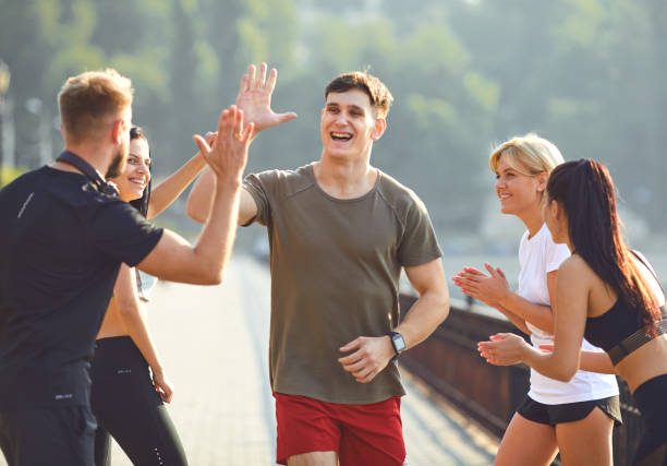 istock Guy runner runs fun with a group of friends in a park 1311049428