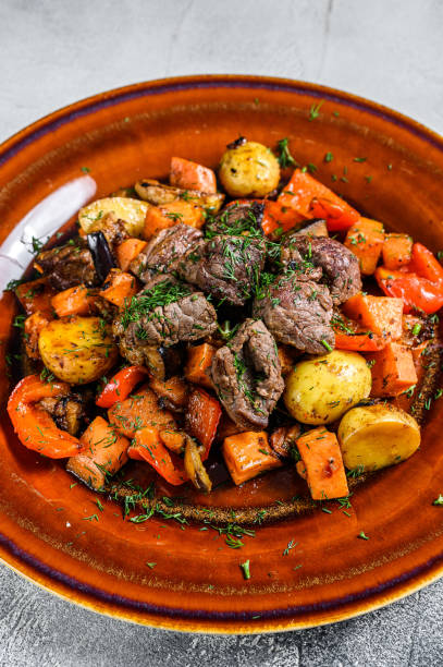 istock Meat stew, goulash on a plate. White background. Top view 1311049500