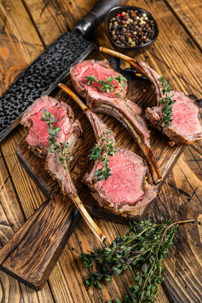 istock Grilled lamb rib chop steaks. wooden background. Top view 1311050194