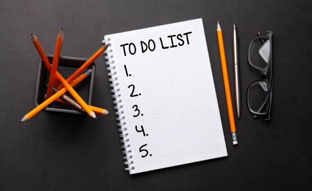 istock Office desk with to do list notepad, supplies and glasses 1311051341