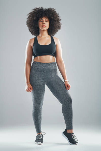 A queen keeps her body strong Studio shot of an attractive and fit young woman wearing sports clothing against a gray background leggings stock pictures, royalty-free photos & images