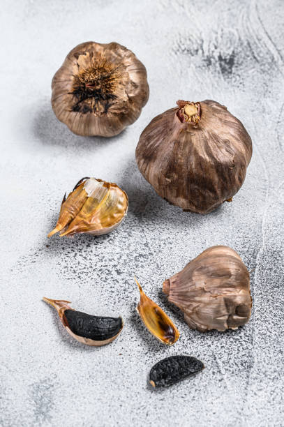 istock Whole balsamic fermented  black garlic. White background. Top view 1311051519
