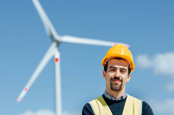istock confident engineer against the wind turbine 1311051581