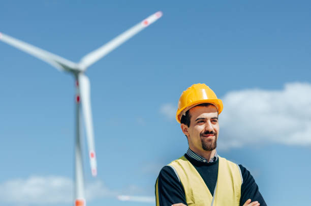 istock confident engineer against the wind turbine 1311051659