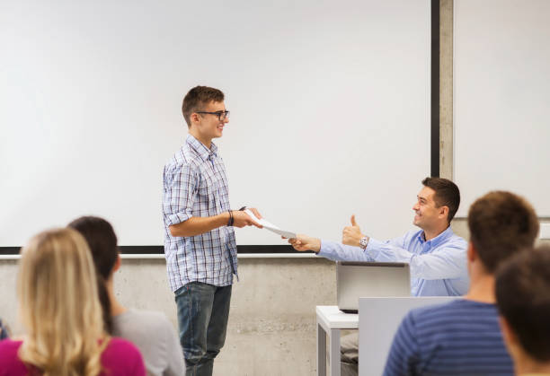 istock group of students and smiling teacher with notepad 1311051684