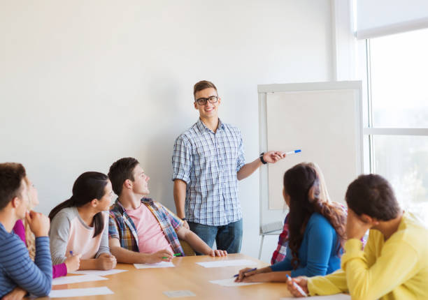 istock group of smiling students with white board 1311051707