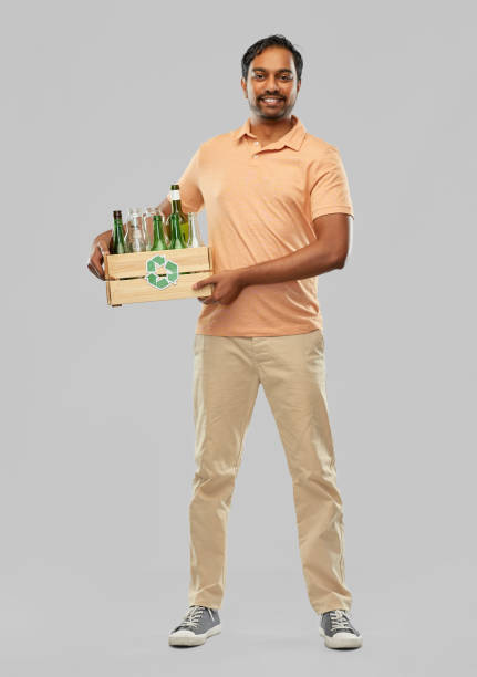 istock smiling young indian man sorting glass waste 1311053292