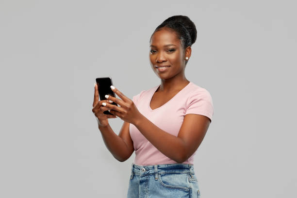 istock happy african american woman using smartphone 1311055874