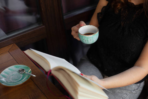 istock girl resting reading a book and drinking coffee 1311056324