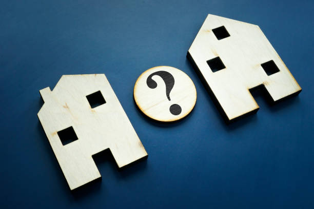 istock Compare houses for property assessment with question mark. 1311057490