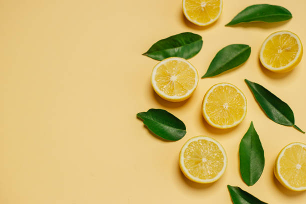 istock Slices of lemon on yellow background 1311058819