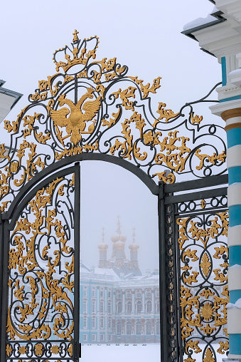 Tsarskoye Selo, Saint-Petersburg, Russia – February 24, 2021: View of The Catherine Palace with The Church of The Resurrection through the open Palace Gate