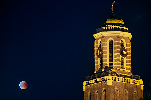 Blood moon of 2018 with the Peperbus church tower in Zwolle - full Lunar Eclipse in the night sky