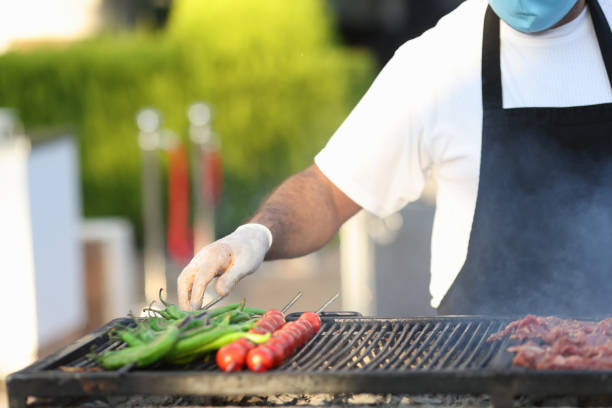 istock Chef preparing grilled vegetables and meat closeup 1311060910