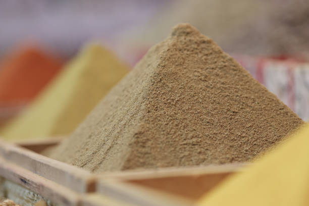 Spices are pouring in shape of pyramid closeup. Sale of spices and seasonings concept