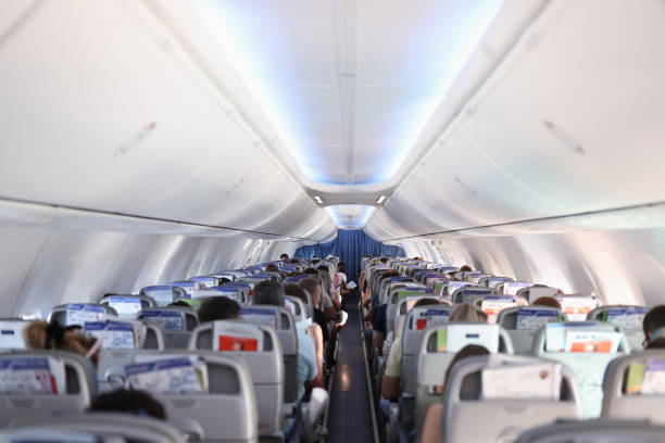 istock Passengers sitting in seats of plane back view 1311060950