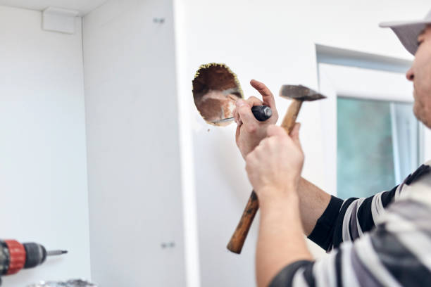 istock Handyman worker making hole for airduct ventilation in the kitchen. 1311061422